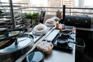 a buffet line with dishes and pans and food at Ramada by Wyndham Manila Central in Manila