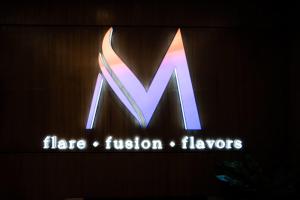 a sign for aeria fusion flayers on a wall at Ramada by Wyndham Manila Central in Manila