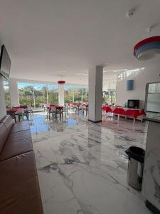 an empty room with tables and chairs in a building at San Cataldo Hotel in Faggiano