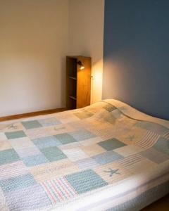 a bedroom with a bed with a quilt on it at Vabaduse Apartment - külaliskorter Kärdlas in Kärdla