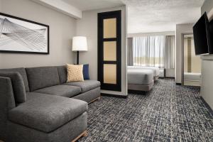 a hotel room with a couch and a bed at Hyatt Place Richmond - Innsbrook in Short Pump