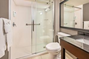 a bathroom with a shower and a toilet and a sink at Comfort Inn Alma - Lac-Saint-Jean in Alma +45 photos