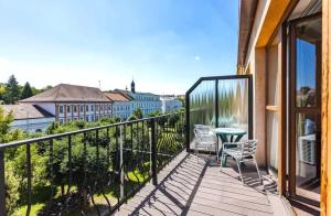 a balcony with a table and chairs and a view at Teplice Plaza in Teplice