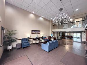 an office lobby with a blue couch and a chandelier at Comfort Inn Feasterville - Trevose in Trevose