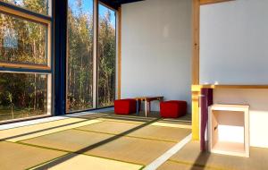 a room with large windows and a table and chairs at Hotel KAZENOIRO in Iioka +92 photos