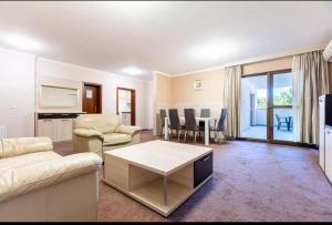 a living room with a couch and a table at Teplice Plaza in Teplice +24 photos
