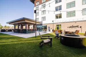 a park with chairs and a table and a building at The Hotel Rambler Montgomery, Tapestry Collection By Hilton in Montgomery