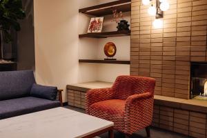 a waiting room with a chair and a table at The Hotel Rambler Montgomery, Tapestry Collection By Hilton in Montgomery +31 photos