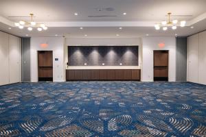 a large room with a large screen in the middle at The Hotel Rambler Montgomery, Tapestry Collection By Hilton in Montgomery