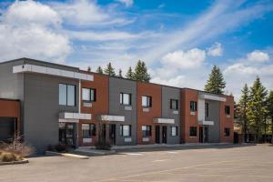 an empty parking lot in front of a building at Ramada by Wyndham Laval in Laval