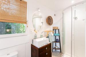 a bathroom with a sink and a mirror at Chambre d'hôtes La Beunaise in Rochefort +20 photos
