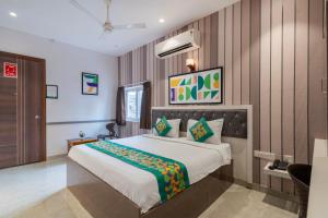 a bedroom with a large bed in a room at Treebo Imperia, Kommadi in Visakhapatnam