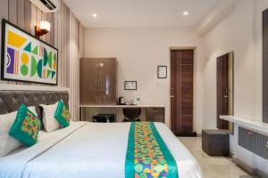 a bedroom with a large bed and a desk at Treebo Imperia, Kommadi in Visakhapatnam +32 photos