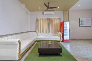 a living room with a white couch and a table at Treebo Imperia, Kommadi in Visakhapatnam