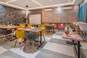 a restaurant with tables and chairs in a room at Treebo Imperia, Kommadi in Visakhapatnam