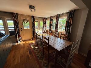 a dining room with a wooden table and chairs at Rising Sun Rustic Retreat in Roach +40 photos