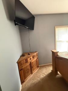 a room with a wooden cabinet and a window at Rising Sun Rustic Retreat in Roach