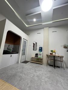 a large room with a kitchen and a table at Nok Homestay in Pangururan