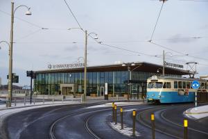 a blue and white train pulling into a train station at Center Hotel - Sure Hotel by Best Western in Gothenburg