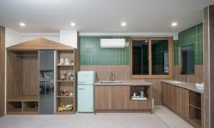 a kitchen with a refrigerator and a sink at Bugok Hanseong Hotel in Changnyeong