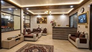 a large living room with couches and a tv at hotel chandigarh pavilion in Chandīgarh +6 photos