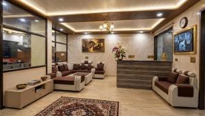 a large living room with couches and a tv at hotel chandigarh pavilion in Chandīgarh