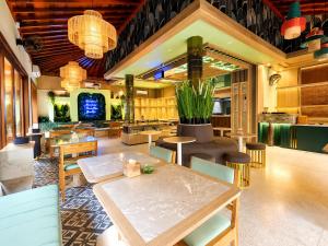 a dining room with a table and chairs at Puri Sading Hotel in Sanur