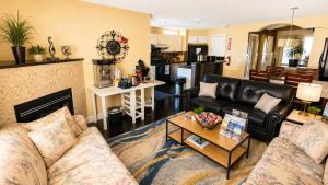 a living room with a couch and a table at Tuscan Ridge Guesthouse Calgary West in Calgary