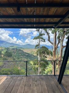 a room with a view from a wooden deck at Eden Heaven Villa in Nuwara Eliya