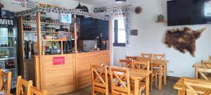 a dining room with wooden tables and chairs at Domek MIŚ Na Stoku in Tylicz +15 photos