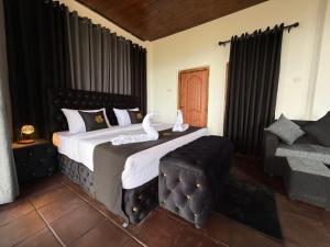 a bedroom with a large bed with swans on it at Eden Heaven Villa in Nuwara Eliya