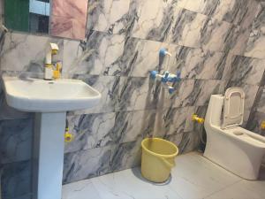 a bathroom with a sink and a toilet at Hotel Youvraj Inn in Ghaziabad +6 photos