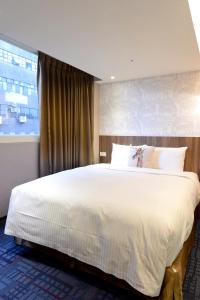 Postel nebo postele na pokoji v ubytování Ark Hotel - Changan Fuxing方舟商業股份有限公司