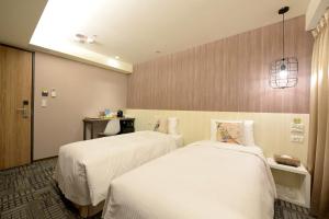 Postel nebo postele na pokoji v ubytování Ark Hotel - Changan Fuxing方舟商業股份有限公司