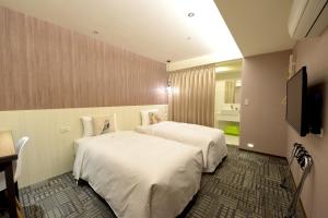 Кровать или кровати в номере Ark Hotel - Changan Fuxing方舟商業股份有限公司