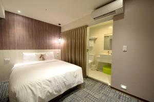 Postel nebo postele na pokoji v ubytování Ark Hotel - Changan Fuxing方舟商業股份有限公司