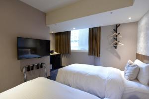 Postel nebo postele na pokoji v ubytování Ark Hotel - Changan Fuxing方舟商業股份有限公司