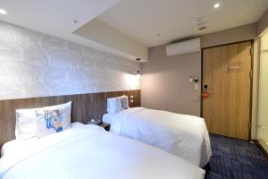 Postel nebo postele na pokoji v ubytování Ark Hotel - Changan Fuxing方舟商業股份有限公司