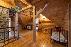 a large room with wooden floors and a wooden ceiling at Dom dla 16 osób z bilardem - Ino Zajrzyj in Ustroń