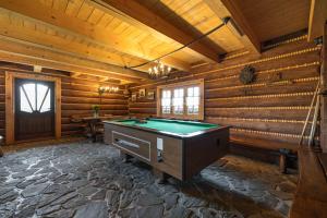 a pool table in a room with wooden walls at Dom dla 16 osób z bilardem - Ino Zajrzyj in Ustroń