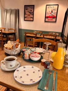 a table with plates of food and a cup of coffee at Le Grand Hotel Restaurant in Aups