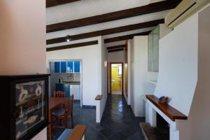 a living room with a table and a dining room at Camping Residence Costa Verde in Ricadi