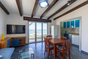 a kitchen and dining room with a table and a television at Camping Residence Costa Verde in Ricadi