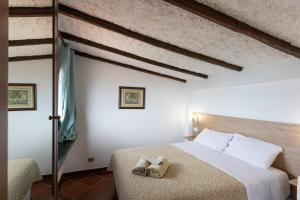 a bedroom with a bed with two towels on it at Camping Residence Costa Verde in Ricadi