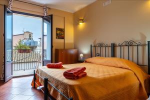 a bedroom with a bed and a large window at Bed and Breakfast San Domenico in Realmonte