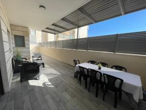 a room with a table and chairs on a balcony at Apartment Eilat in Eilat
