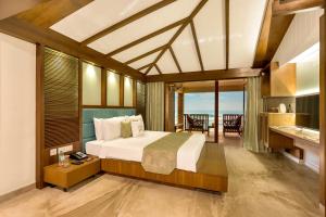 a bedroom with a bed and a view of the ocean at Welcomhotel by ITC Hotels, Kences Palm Beach, Mamallapuram in Mahabalipuram +64 photos
