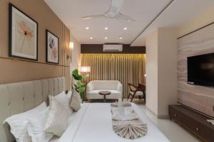 a hotel room with a bed and a television at Hotel Lohara Inn in Chandrapur