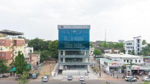 a building with a sign on it in a city at Hotel Lohara Inn in Chandrapur