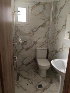 a bathroom with a toilet and a sink at Valasis Studios in Argassi +28 photos